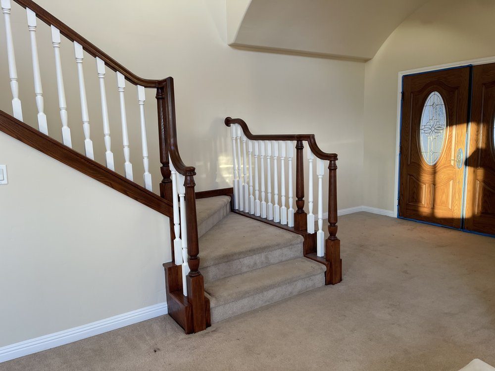 Painter cutting in clean ceiling lines during an interior painting project